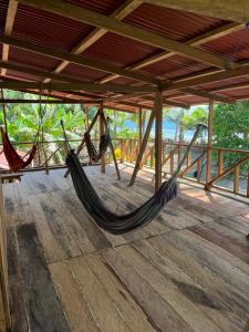 a couple of hammocks hanging from a roof at Hostal San Mabel Herping - Playa Cuevita in El Valle