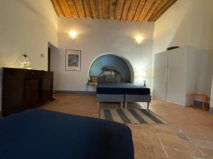 a bedroom with a bed and a table in a room at La Fabbrica in Calci