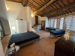 a bedroom with a large bed and a living room at La Fabbrica in Calci