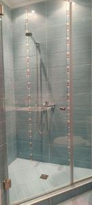a shower with a glass door in a bathroom at Europroperties Zlatna Kotva Apartments in Golden Sands