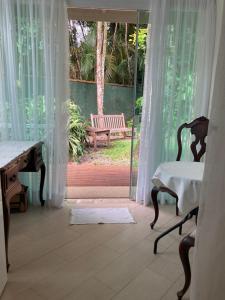 um quarto com uma secretária e uma janela com um banco em Pouso Costa do Sol em Bertioga