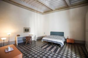 A bed or beds in a room at La Fabbrica