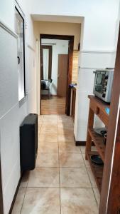 a hallway of a room with a kitchen and a microwave at Lavalle III in Venado Tuerto