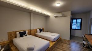 Ένα ή περισσότερα κρεβάτια σε δωμάτιο στο ชวนไดอารี่ Chuan Diary