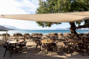 a group of tables and chairs on the beach at Aroma of the Sea in Kissamos