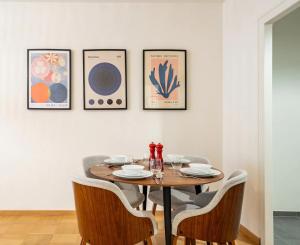 uma sala de jantar com uma mesa de madeira e cadeiras em Stylish Lakeside Home by the Jet d'Eau em Genebra