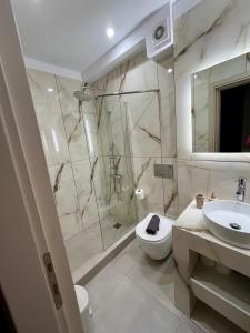 a bathroom with a shower and a toilet and a sink at Mountain Retreat I - Karpenisi in Karpenisi