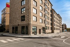 a tall brick building on the corner of a street at Stylish Urban Home in Stockholm in Stockholm