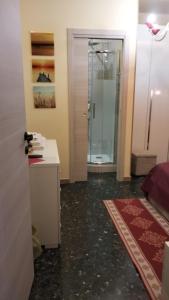 a bathroom with a walk in shower and a glass door at La Casa di Sonia in Savona