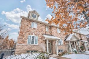 a brick house with snow in front of it at Designer 4BR Executive Townhome w/Parking in Mississauga