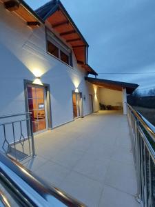 a balcony of a house with lights on it at Romantic Lodge in Banja Luka