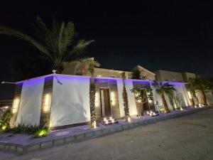 a building with lights on it at night at Sky2030Group in Dammam