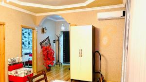 a living room with a white cabinet and a table at AkbA-Frame1 in İsmayıllı