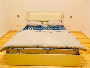 a large bed in a small room with a mattress at AkbA-Frame1 in İsmayıllı