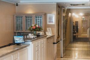 a hotel room with a reception counter with flowers on it at Hotel Daniel in Munich