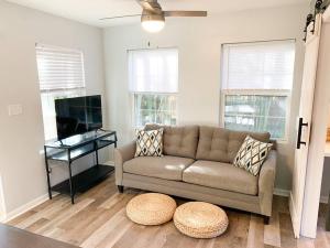 a living room with a couch and a flat screen tv at Tiny house- near Duke Univ/Hospital, walk to food in Durham