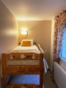 a small bedroom with a bed with stars on it at Le Logis de Bamby in Ancelle