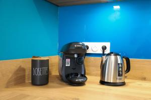 two coffee cups and a coffee maker on a counter at Le Beluga XL - Confort et proximité Airbus in Colomiers