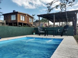 a tiny house with a pool and a table and chairs at Villa Nicolasa in Villa Yacanto +20 photos
