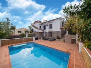 a swimming pool in front of a house at Great Holiday home in Benissa with pool in Benissa