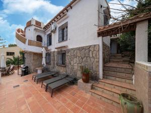 a house with a patio and stairs in front of it at Great Holiday home in Benissa with pool in Benissa