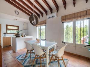 a kitchen and dining room with a table and chairs at Great Holiday home in Benissa with pool in Benissa