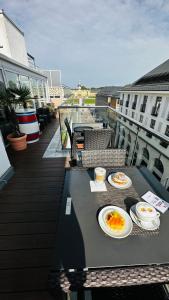 卡爾斯魯厄的住宿－埃姆馬克特酒店，阳台上的一张桌子上放着两盘鸡蛋