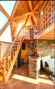a kitchen with a staircase in a wooden house at Domo Vientos del Sur in Ancud