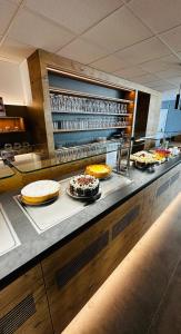 a buffet line with cakes and desserts on display at Hotel Am Markt in Karlsruhe