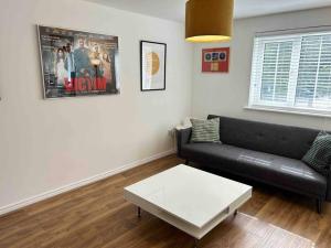 a living room with a couch and a coffee table at 1 Bed Greater London Flat next to Station & Free Parking in Romford