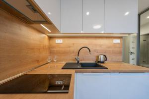 a kitchen with a sink and a counter top at J Komfortný byt na skok od centra in Košice