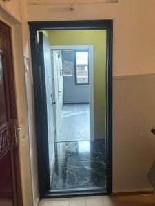 a mirror with a reflection of a hallway at Apartment in Yerevan