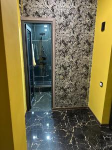 a bathroom with a mirror and a walk in shower at Apartment in Yerevan