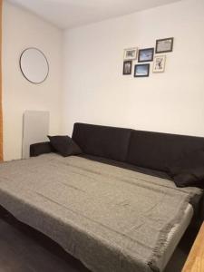 a bed in a room with a black bed frame at Val Thorens Studio 2 personnes et balcon plein Sud in Val Thorens