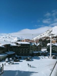 a group of people in the snow in front of a building at Val Thorens Studio 2 personnes et balcon plein Sud in Val Thorens