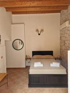 a bedroom with a bed and a mirror on the wall at La Chiusazza in Case Monterosso