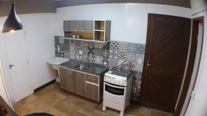 a small kitchen with a sink and a stove at AP3 - 1dorm privado próx Garten Shop-Universidades in Joinville