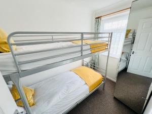 two bunk beds in a room with a door at 2 Bedroom Chalet SB113, Sandown Bay, Isle of Wight in Brading
