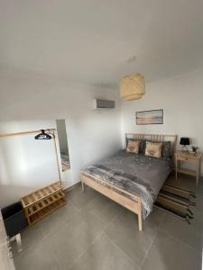 a bedroom with a bed in the corner of a room at Luxury Apartment with pool in historical town and great surfing beaches in Sagres