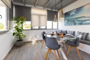 a dining room with a table and chairs at Hidden Gem Villa Aqua Marine - Sea View - Mikri Vigla Beach in Naxos Chora