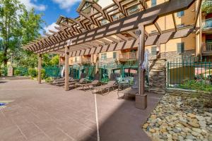 a patio with chairs and a wooden pergola at Baskins Creek Condos in Gatlinburg
