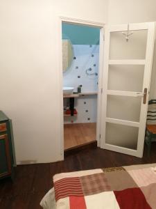 a room with a bathroom with a sink and a mirror at Au Logis de Véchillot in Angoulême