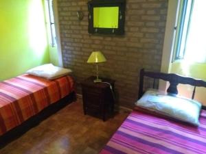1 dormitorio con cama, lámpara y TV en Casa de Campo Mama Lucia en 