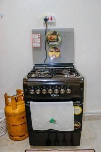 a stove in a kitchen with a towel on it at J&J luxury homes in Kericho