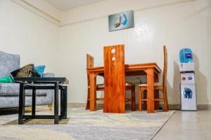 a living room with wooden chairs and a table at J&J luxury homes in Kericho