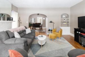 a living room with a couch and a table at Stylish 3-bd Haven in Trendy Cleveland Heights! in Cleveland Heights