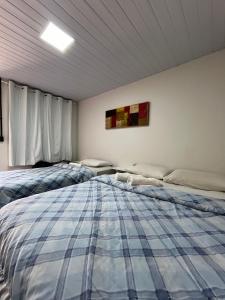 a bedroom with two beds in a room at Social Hostel Café e Bar in Curitiba