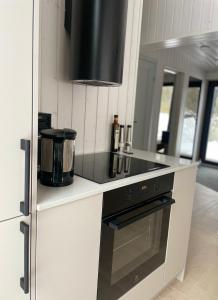 a kitchen with a stove and a counter top at Tondikaku Holiday Home in Otepää