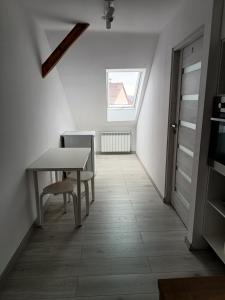 a small dining room with a table and a window at Sleep In Center in Kraków