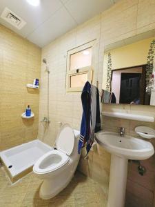 a bathroom with a toilet and a sink at Large Studio Room In-Al khalidiya Abudhabi in Abu Dhabi